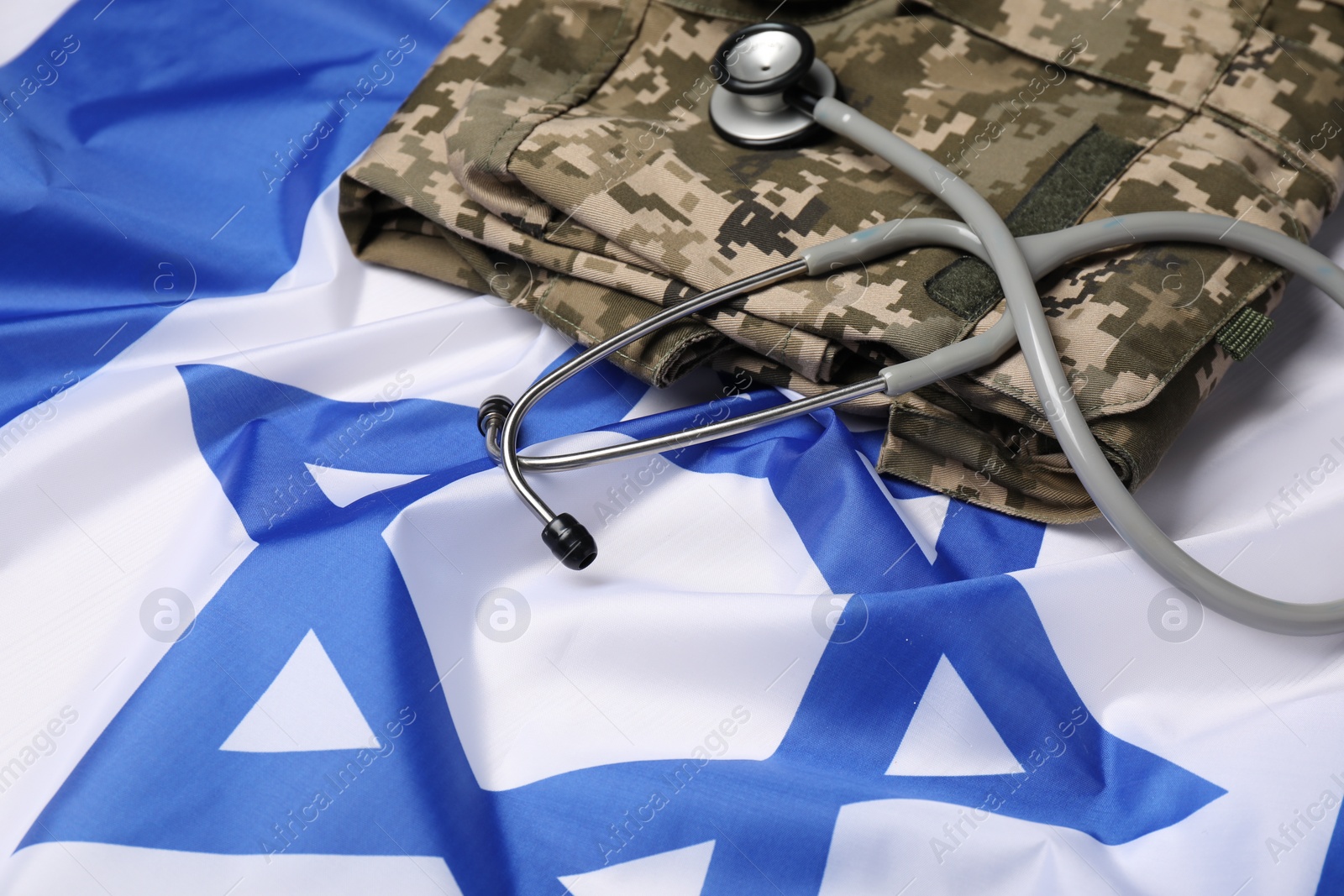 Photo of Stethoscope and military uniform on flag of Israel