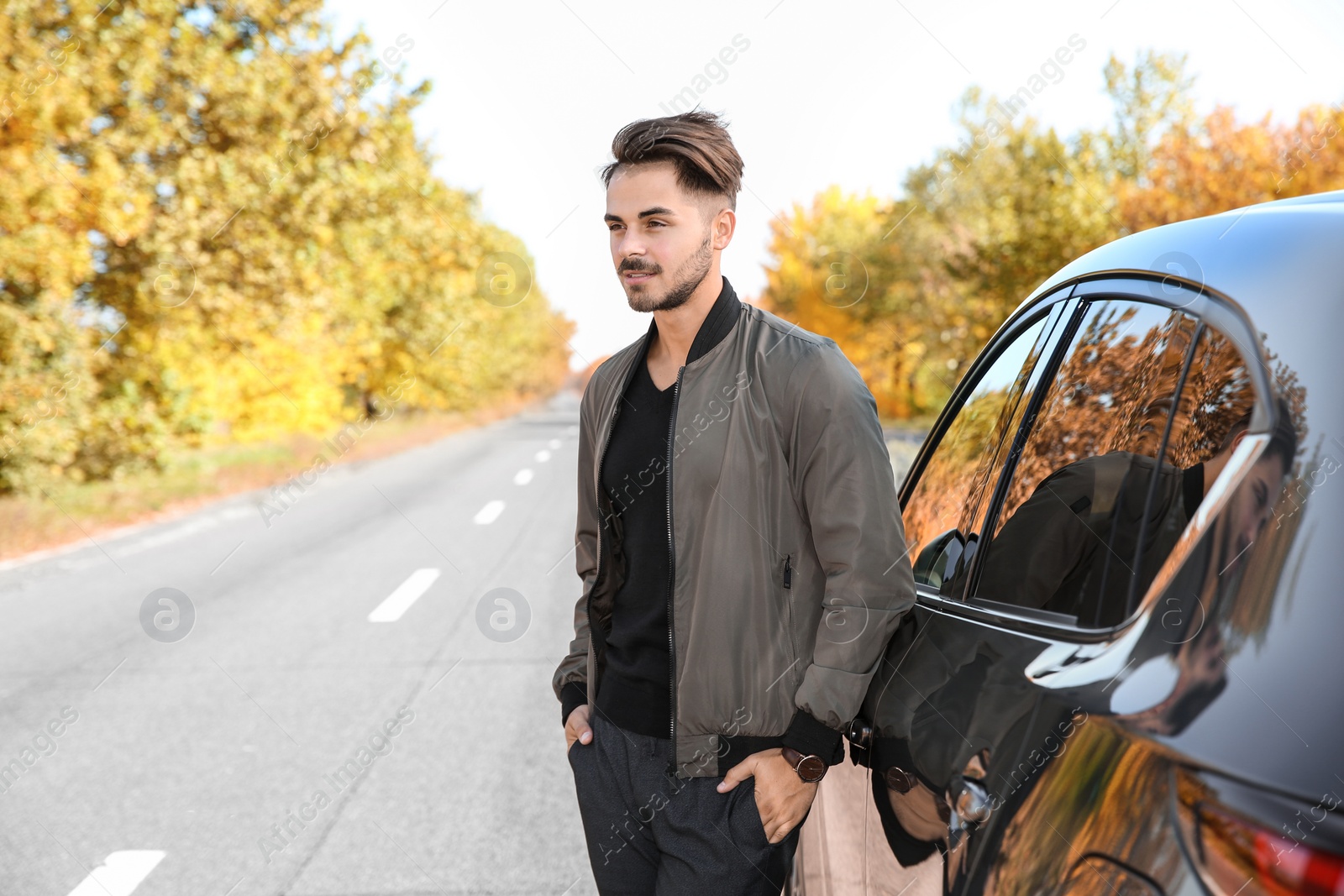 Photo of Young man near modern car on sunny day, outdoors