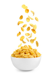 Image of Tasty crispy corn flakes falling into bowl on white background