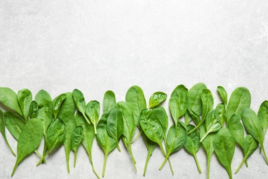 Photo of Fresh green healthy spinach on light table, flat lay. Space for text