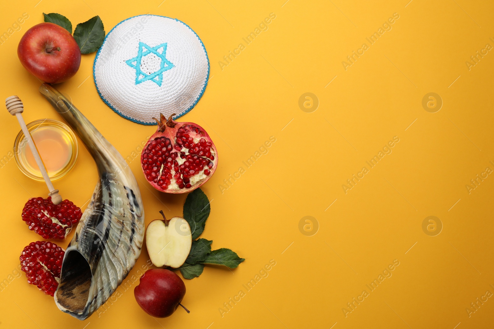 Photo of Flat lay composition with Rosh Hashanah holiday attributes on yellow background. Space for text