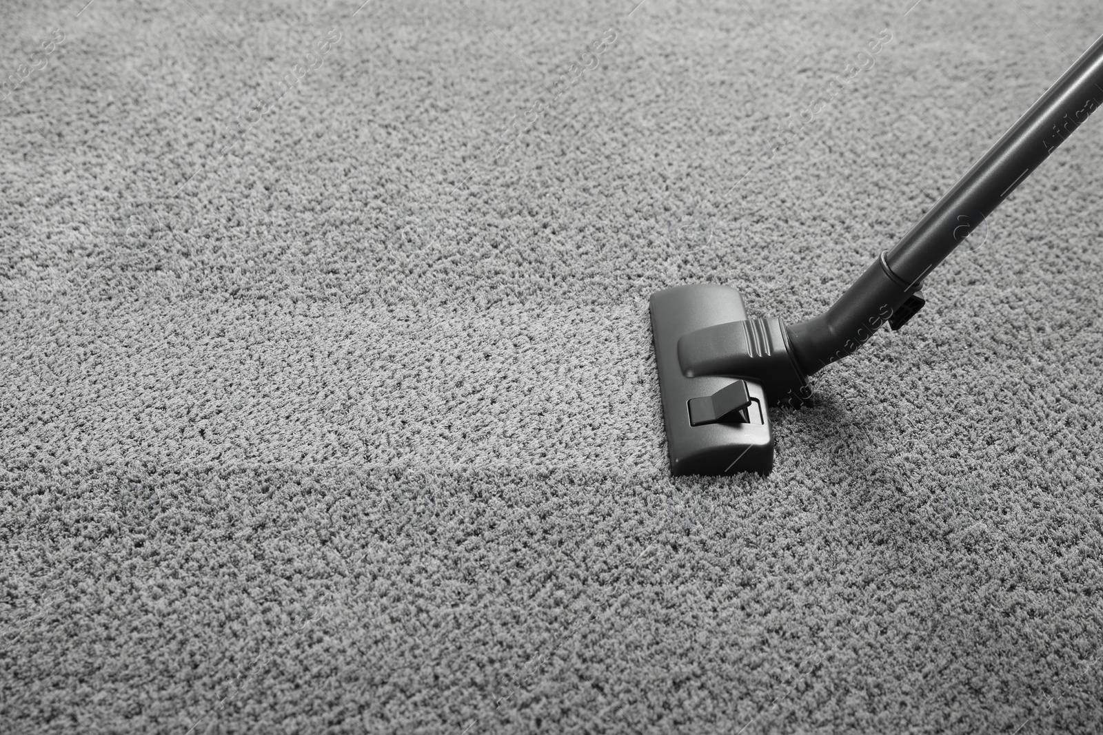 Photo of Vacuuming grey carpet. Clean area after using device. Space for text