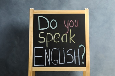 Blackboard with question Do You Speak English on grey background