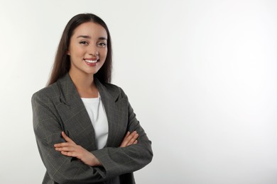 Portrait of happy young woman in stylish jacket on white background. Space for text