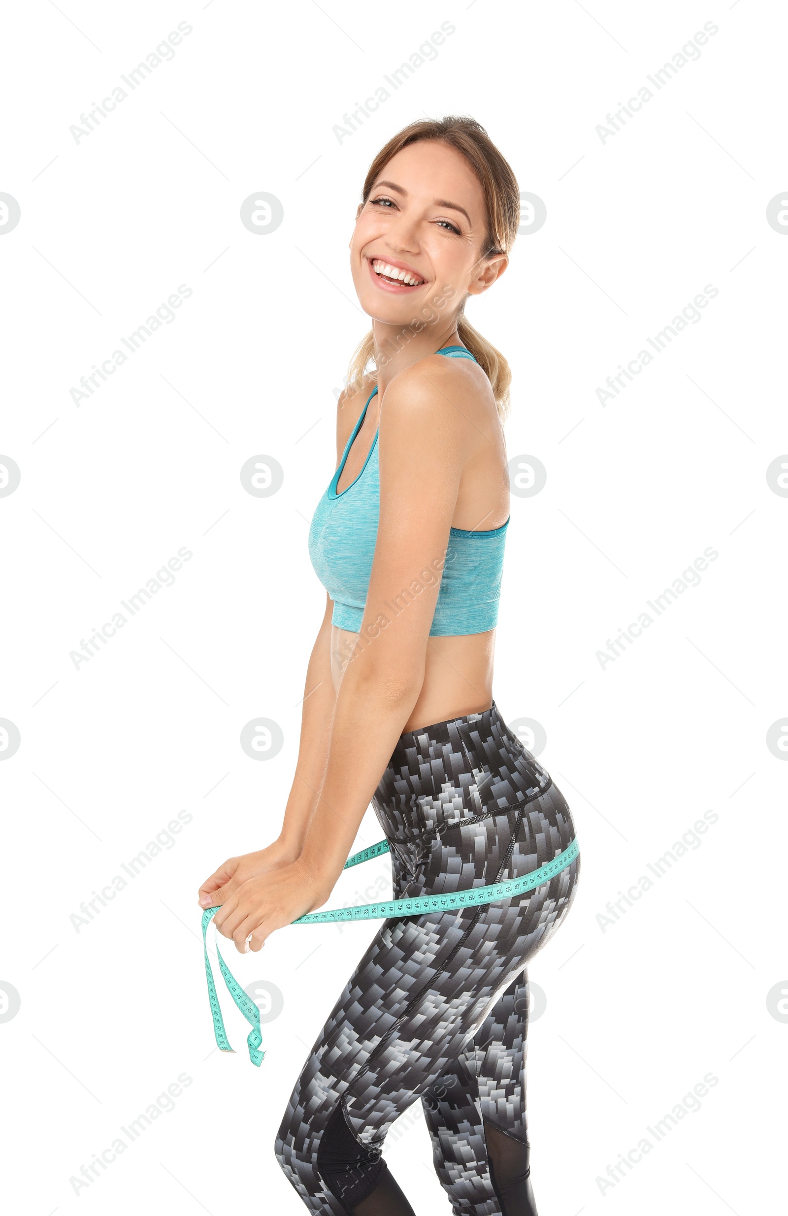 Photo of Happy slim woman in sportswear with measuring tape on white background. Positive weight loss diet results