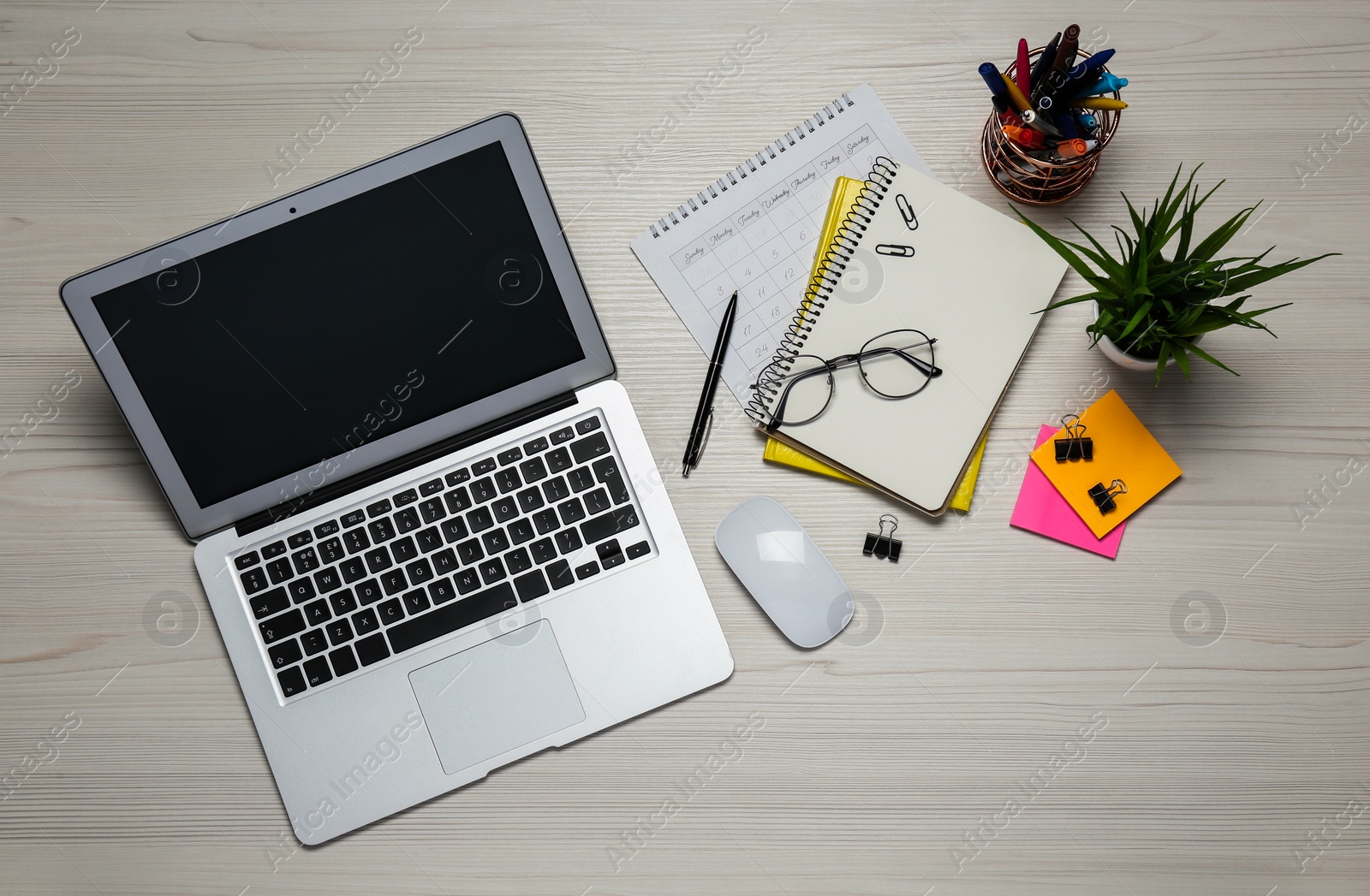 Photo of Modern laptop, glasses and office stationery on white wooden table, flat lay. Distance learning