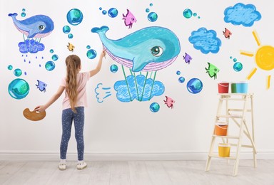 Image of Cute child girl drawing of colorful dye on white wall in room