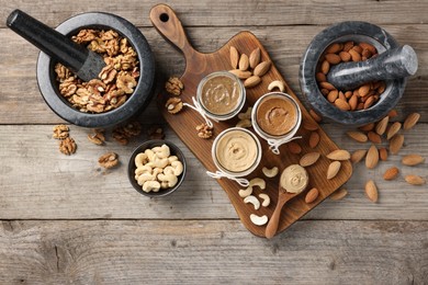 Photo of Making nut butters from different nuts. Fat lay composition on wooden table
