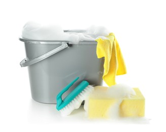 Photo of Plastic bucket with foam and sponge on white background. Cleaning supplies