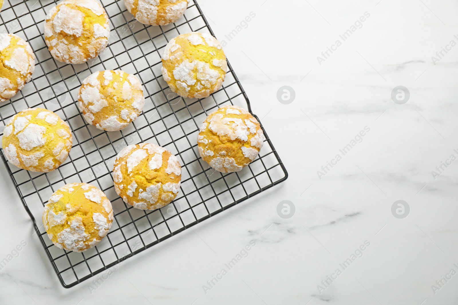 Photo of Tasty homemade lemon cookies on white marble table, top view. Space for text