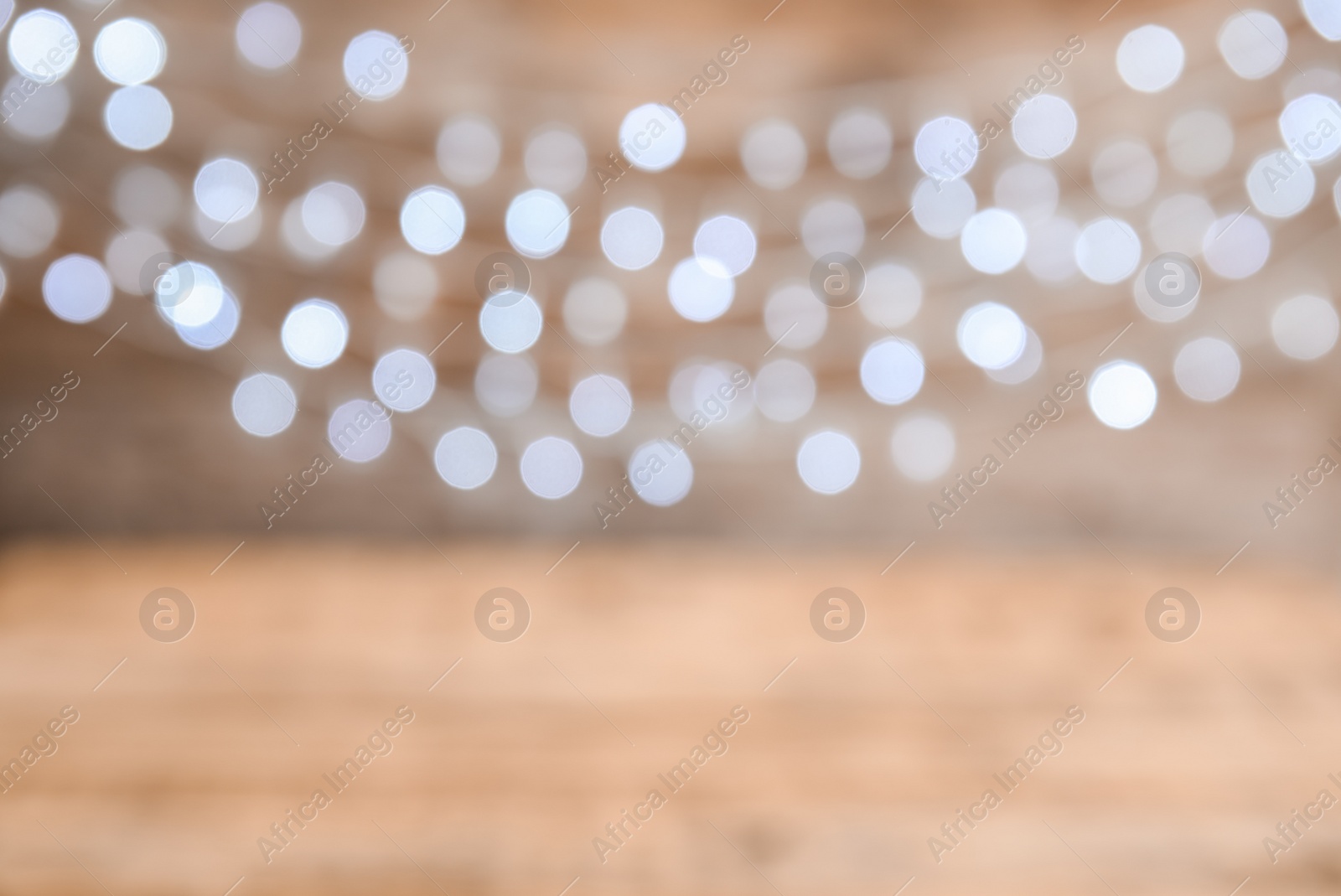 Photo of Blurred view of Christmas lights on color background