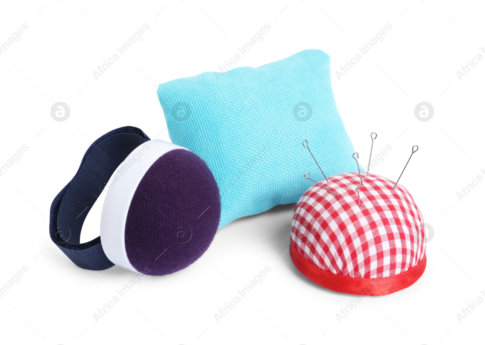 Photo of Pincushions and sewing needles isolated on white