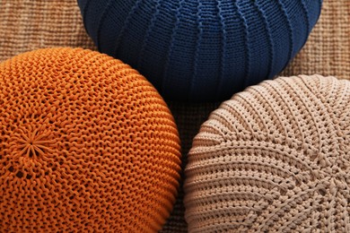 Photo of Stylish comfortable poufs on carpet, above view. Home design