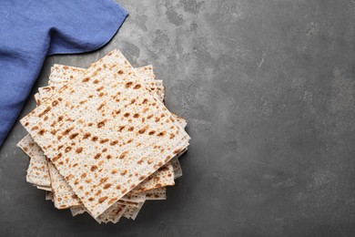 Photo of Stack of matzos on grey table, flat lay. Space for text