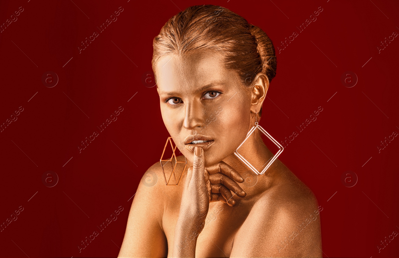 Photo of Portrait of beautiful lady with gold paint on skin against color background