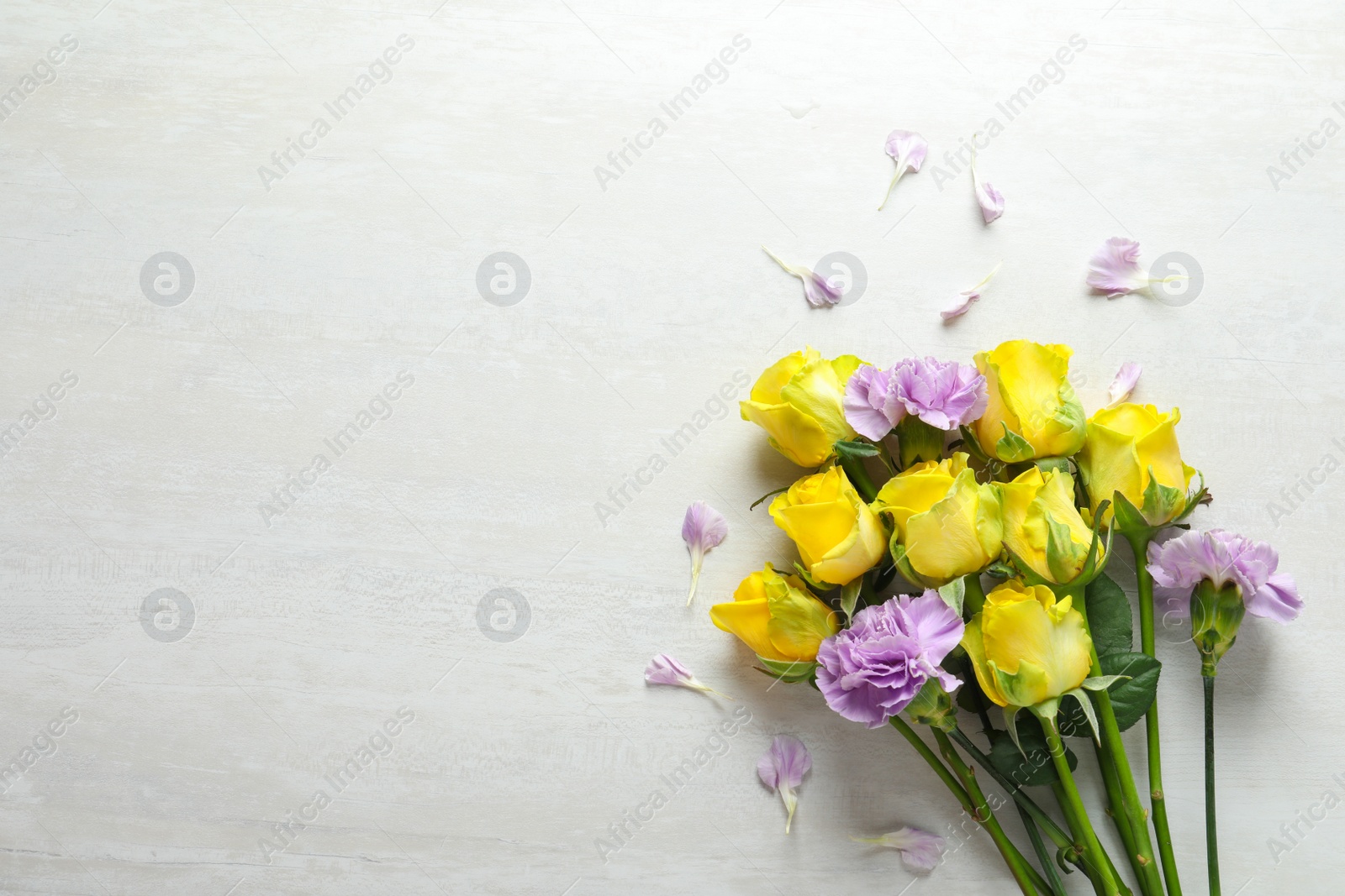 Photo of Flat lay composition with beautiful blooming flowers on light background