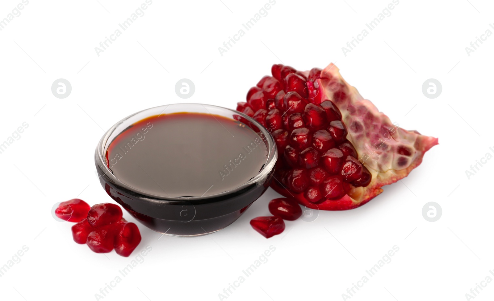 Photo of Bowl of pomegranate sauce and fresh ripe fruit on white background