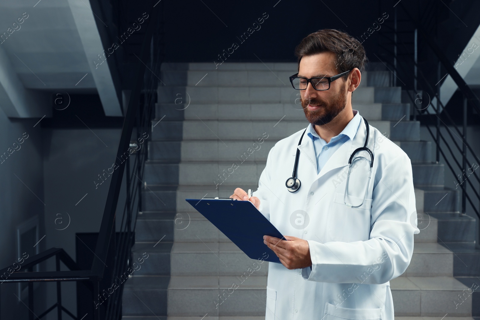 Photo of Doctor with stethoscope and clipboard in hospital