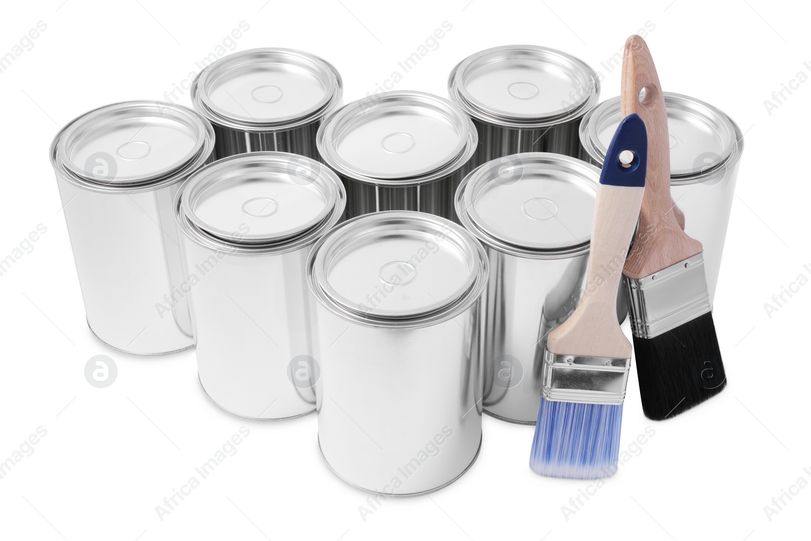 Photo of Cans of paints and brushes on white background