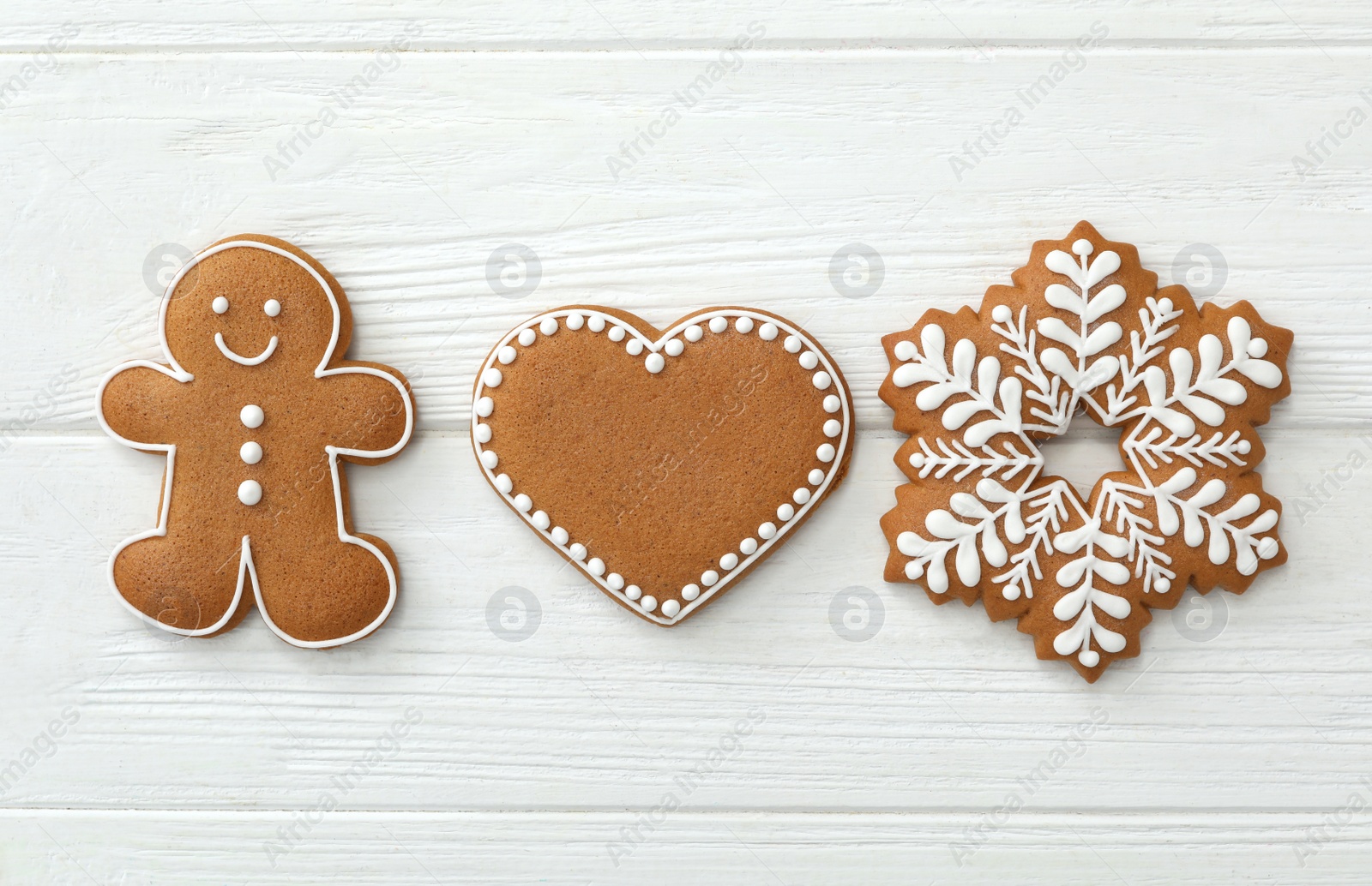 Photo of Different delicious Christmas cookies on white wooden table, flat lay