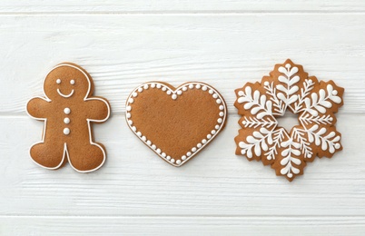 Different delicious Christmas cookies on white wooden table, flat lay