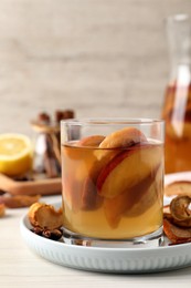 Photo of Delicious compot with dried apple slices on light wooden table