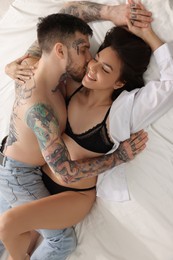 Passionate couple having sex on white bed