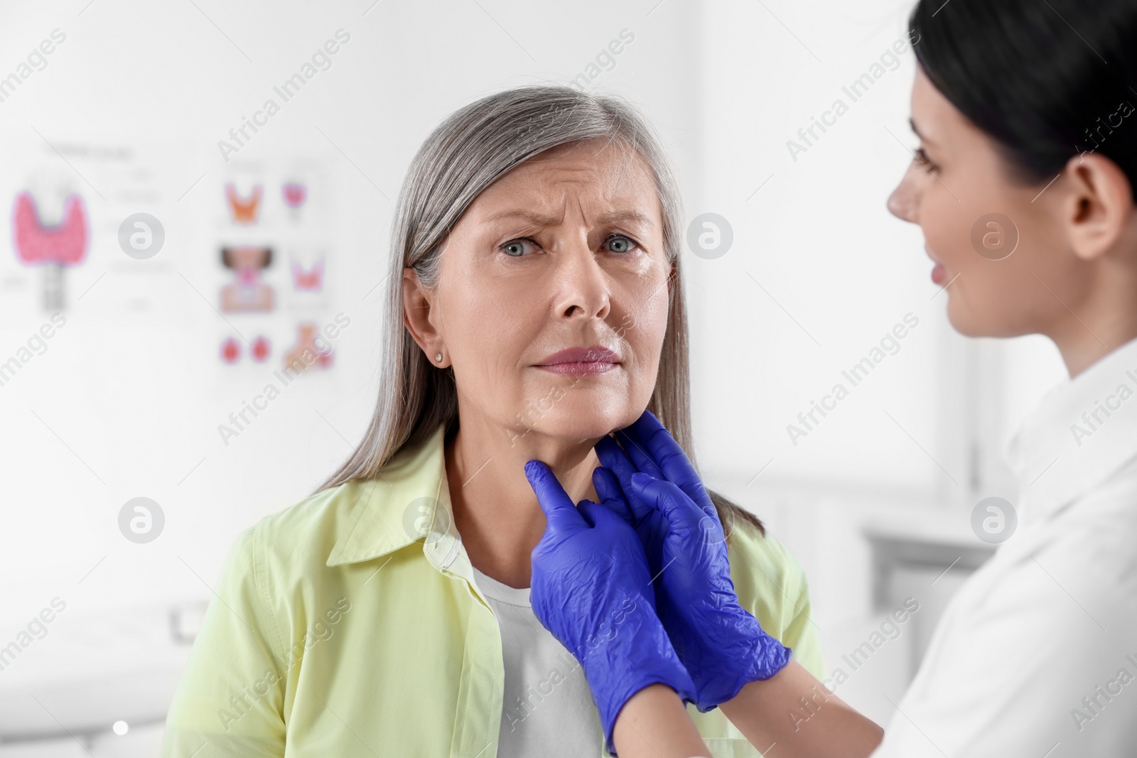 Photo of Endocrinologist examining thyroid gland of patient at hospital