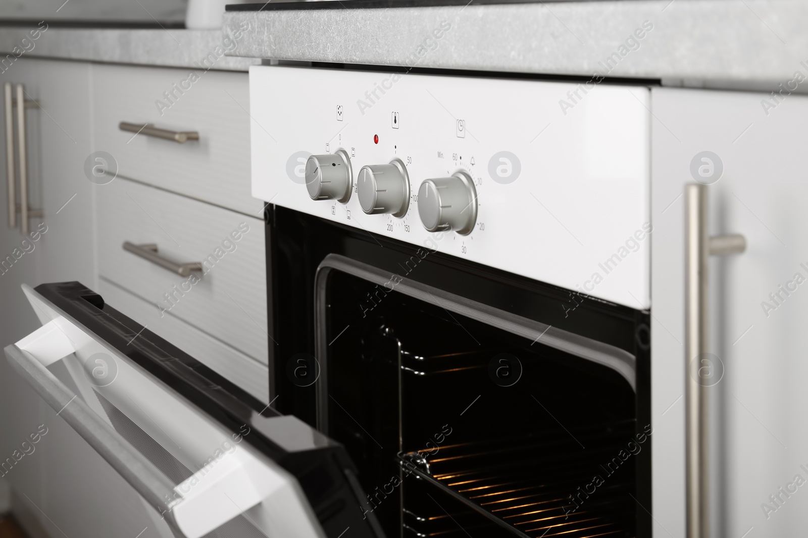 Photo of Open empty electric oven in kitchen, closeup