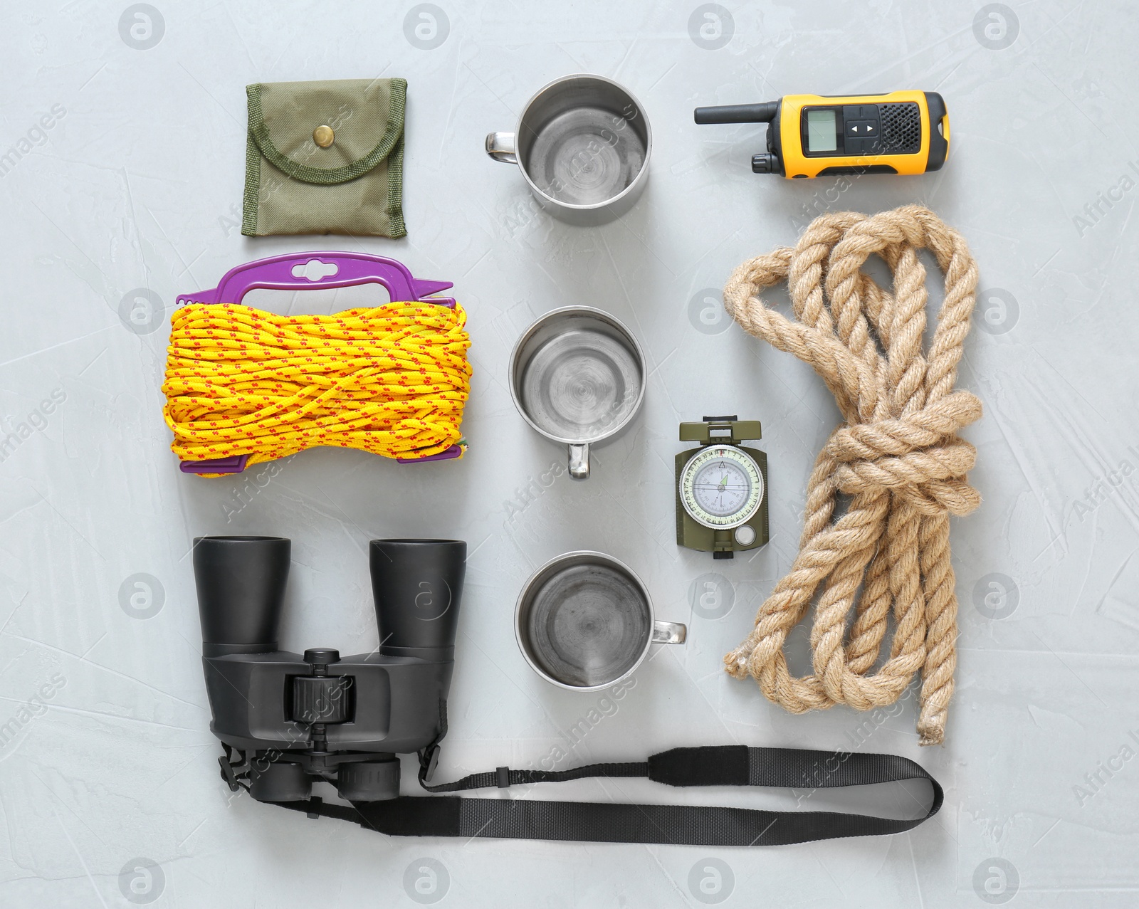 Photo of Flat lay composition with camping equipment on grey background