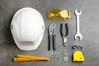 Photo of Flat lay composition with different construction tools on grey background