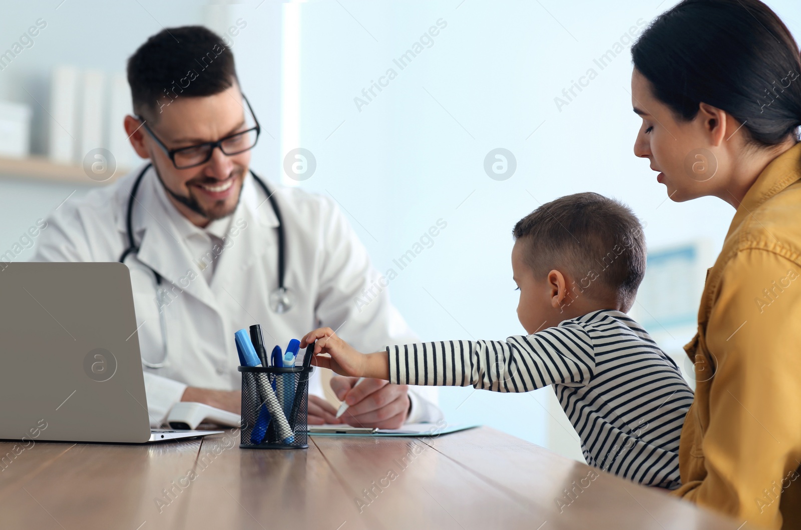 Photo of Mother and son visiting pediatrician in hospital