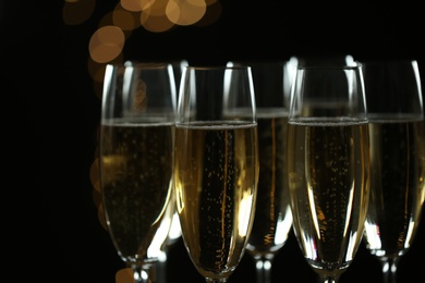 Photo of Many glasses of champagne on blurred background, closeup