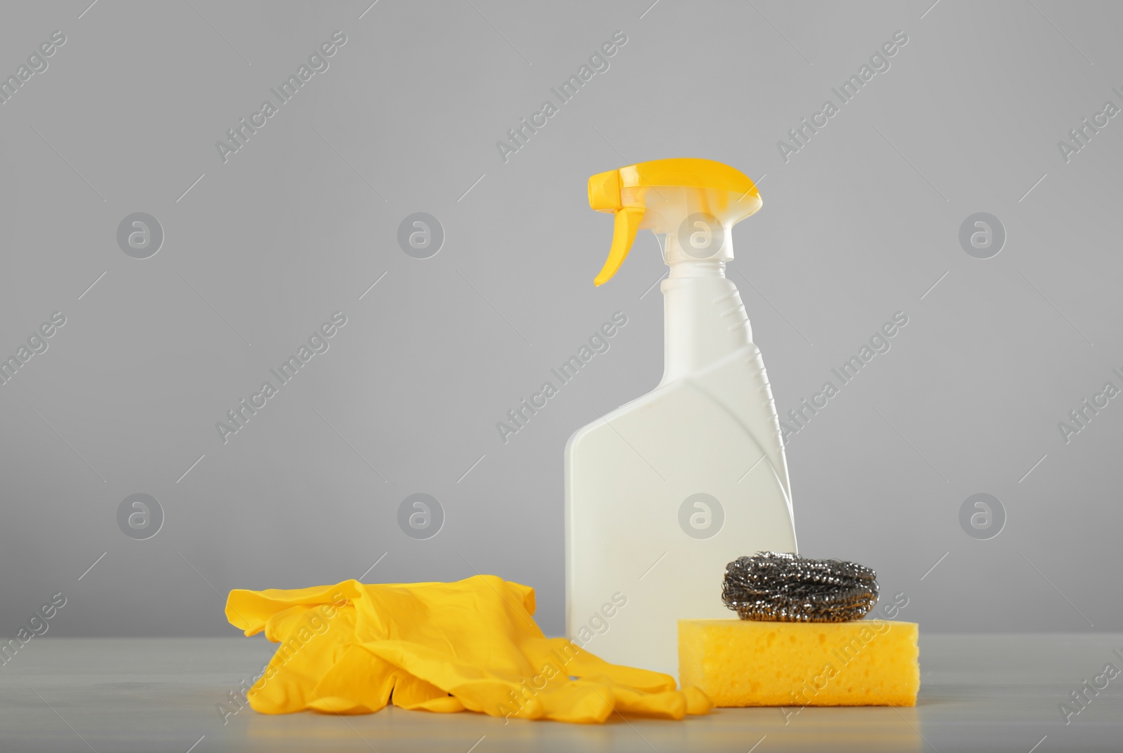 Photo of Bottle of cleaning product and supplies on light table