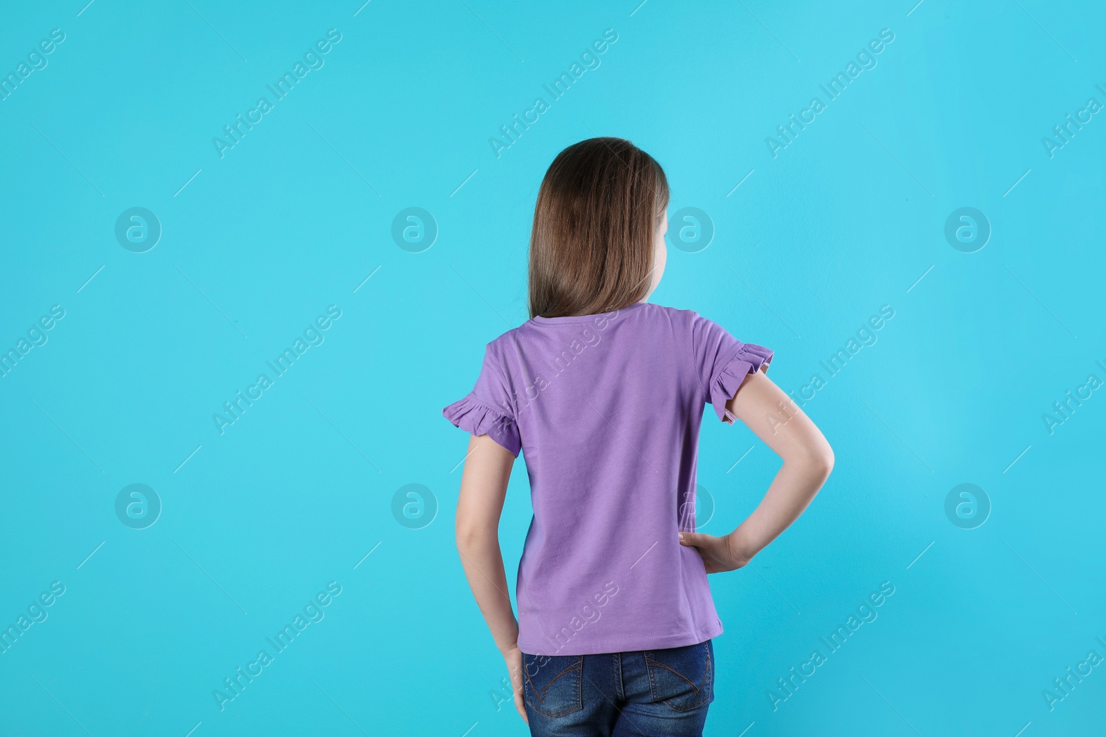 Photo of Little girl in t-shirt on color background. Mockup for design