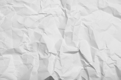 Photo of Sheet of white crumpled paper as background, closeup