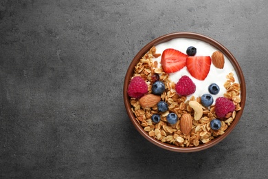 Photo of Tasty homemade granola served on grey table, top view with space for text. Healthy breakfast