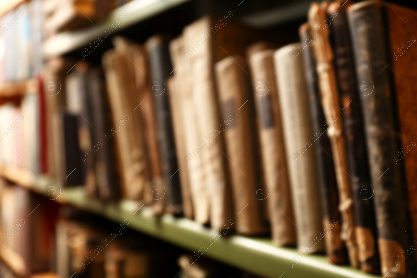 Photo of Blurred view of old books on shelf in library