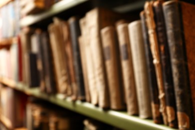 Photo of Blurred view of old books on shelf in library