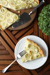 Photo of Tasty leek pie served on wooden table, flat lay