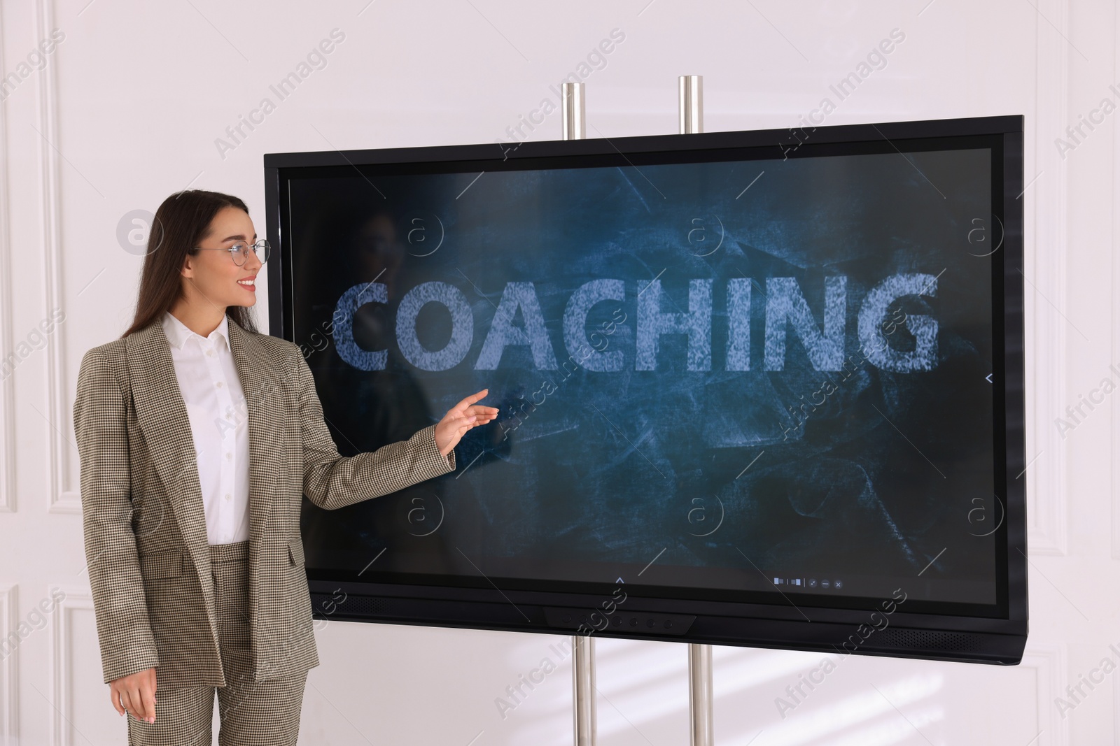 Photo of Business trainer using interactive board in meeting room