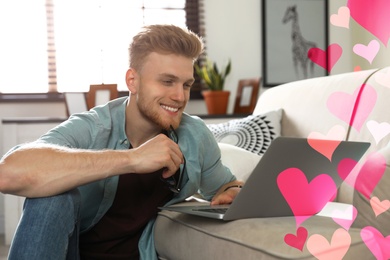 Image of Young man visiting dating site via laptop indoors