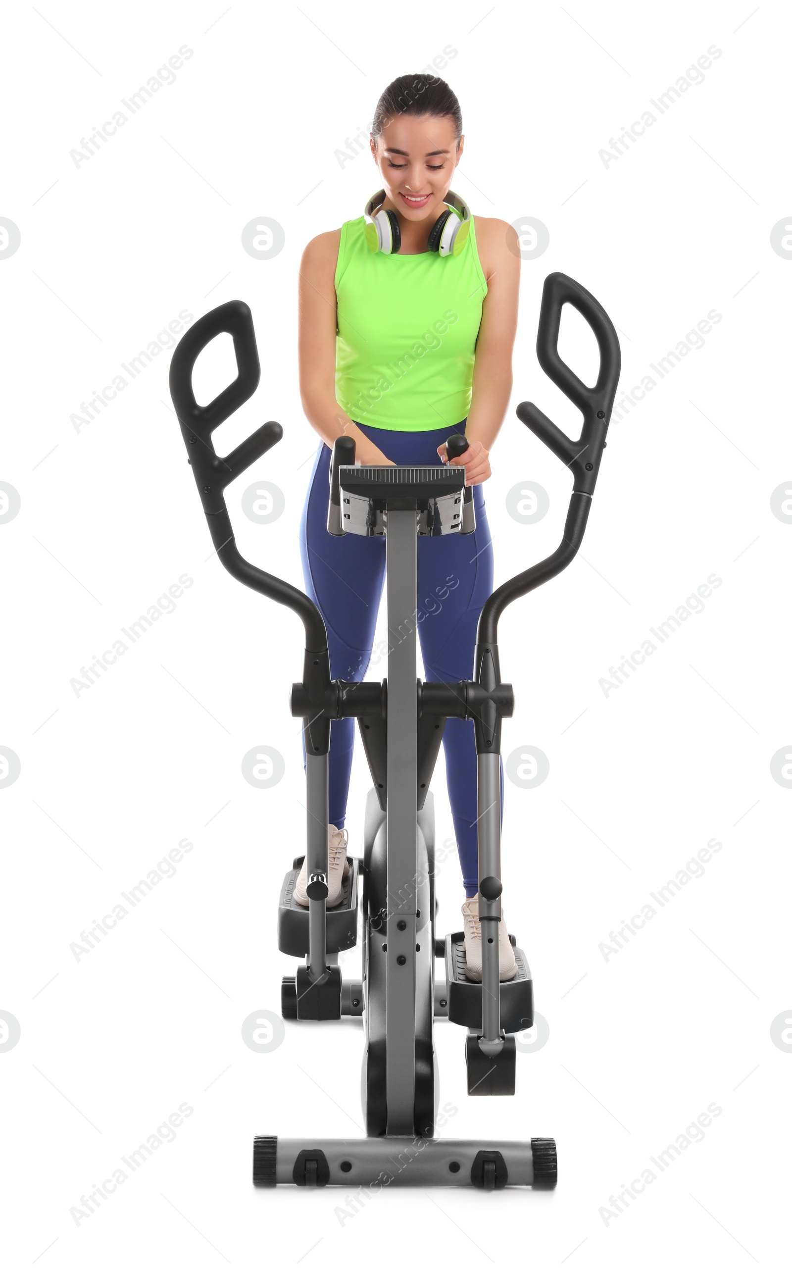 Photo of Woman using modern elliptical machine on white background