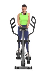 Woman using modern elliptical machine on white background