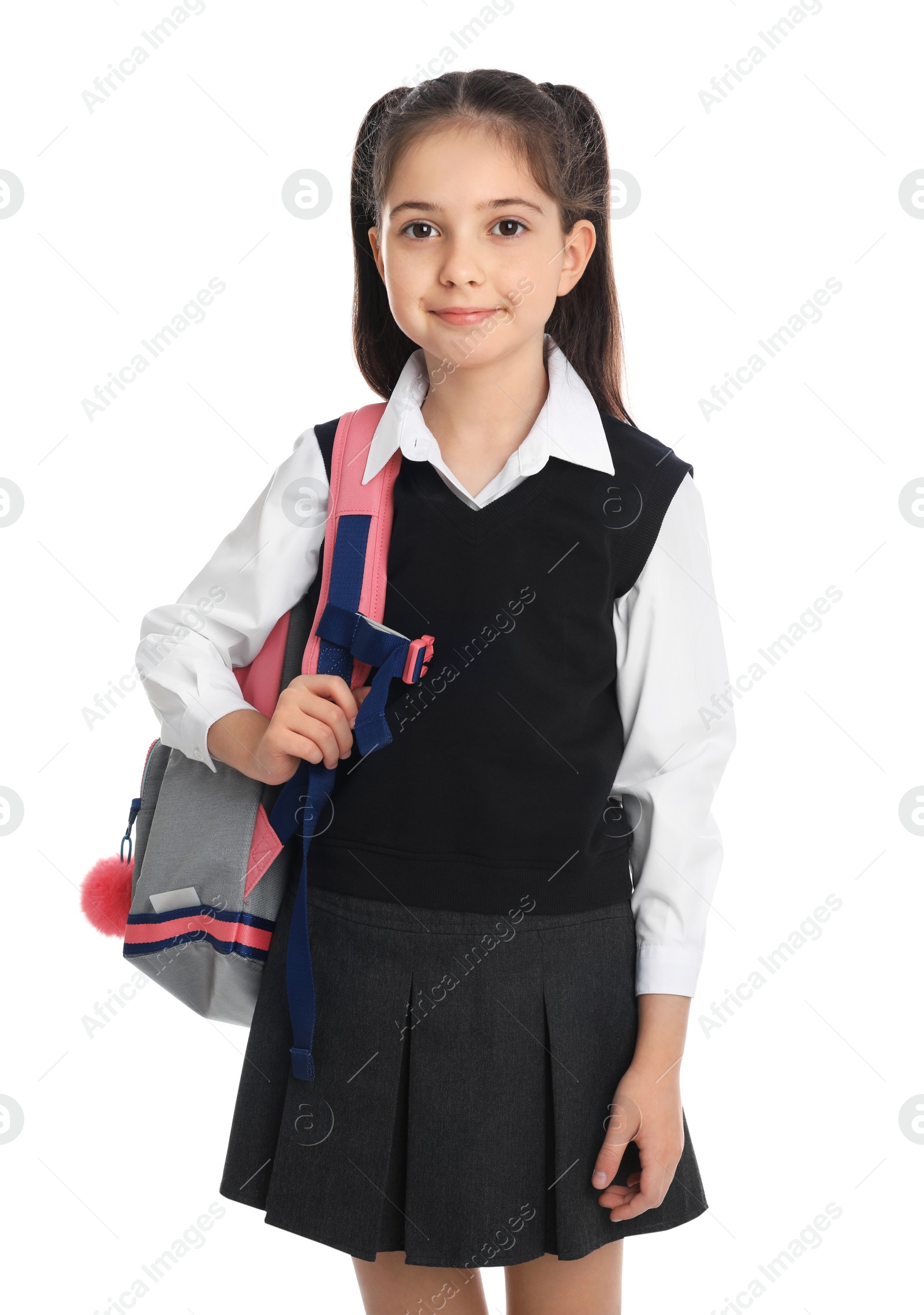 Photo of Little girl in school uniform with backpack on white background