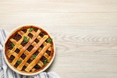 Freshly baked meat pie on white wooden table, top view. Space for text