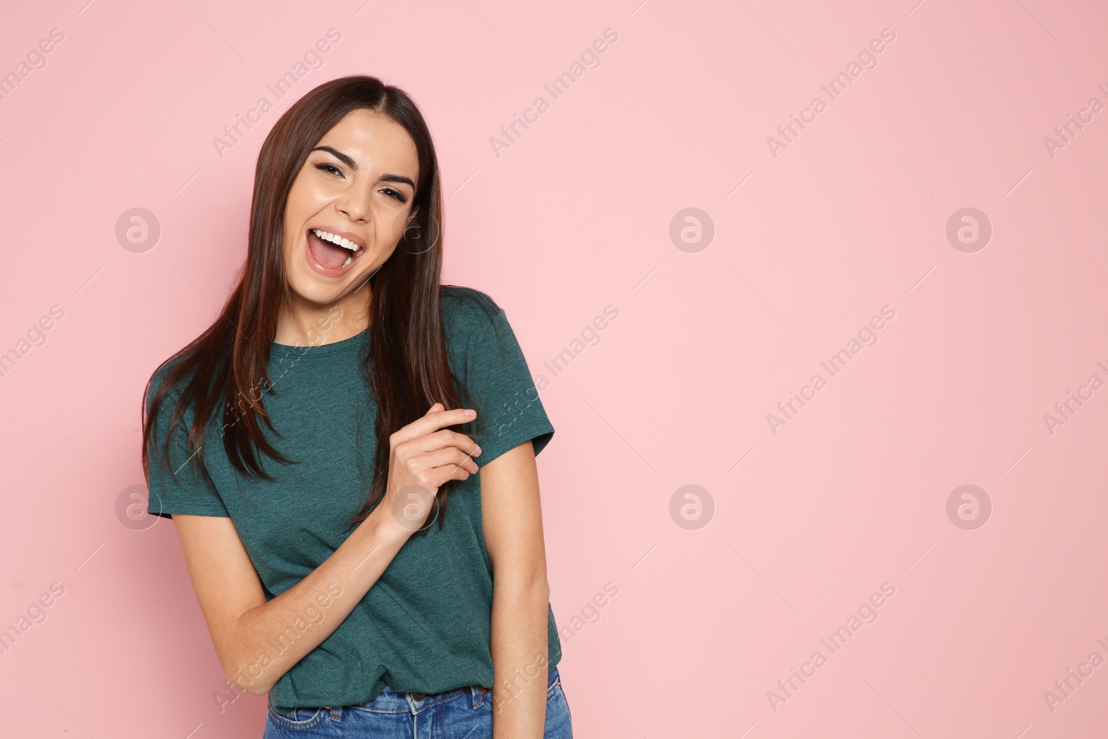 Photo of Portrait of young woman laughing on color background. Space for text