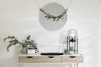 Stylish room decorated with beautiful eucalyptus garland