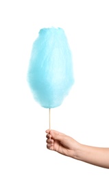 Photo of Woman holding sweet blue cotton candy on white background, closeup view