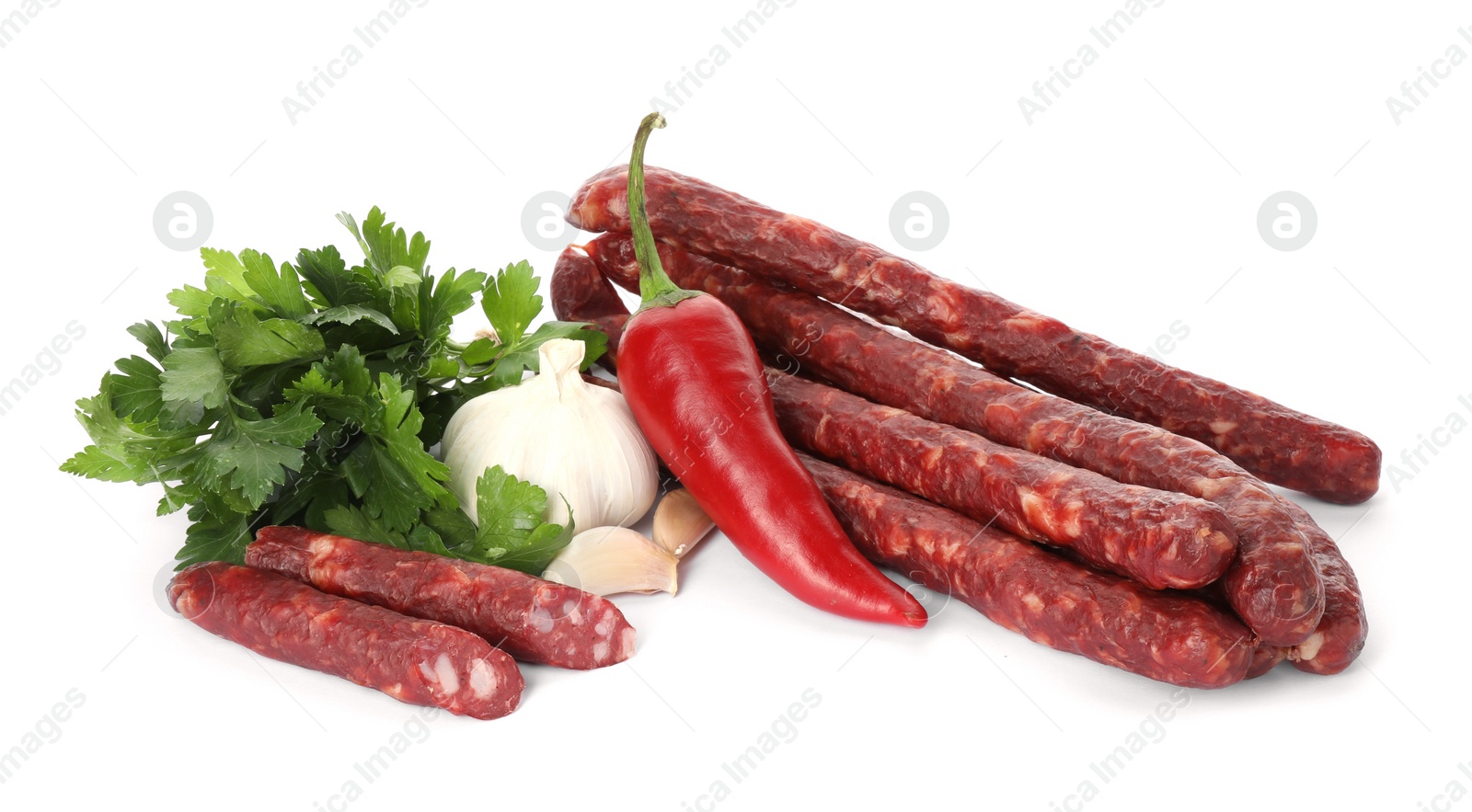 Photo of Thin dry smoked sausages and different spices isolated on white